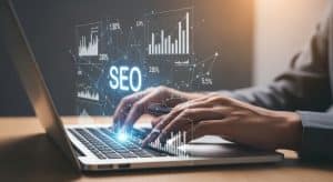 fingers typing on a laptop with SEO hovering over them