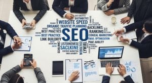 people sitting around a table brainstorming abot SEO